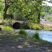 Culvert along an irrigation ditch conveying Gila water beneath a rural road. Photo Credits: Mary Harner