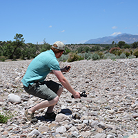 Rosdail filming dry channel of Mogollon Creek with Osmo handheld camera. Photo Credits: Mary Harner