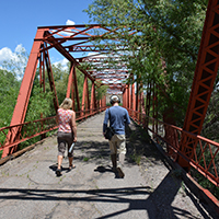 Martha Cooper and Jacob Rosdail walking across Iron Bridge. Photo Credits: Mary Harner