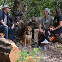 Mike and Carol Fugagli share stories of the natural history of the Gila while their dogs stand by along a pond at the Gila River Farm. Photo Credits: Mary Harner